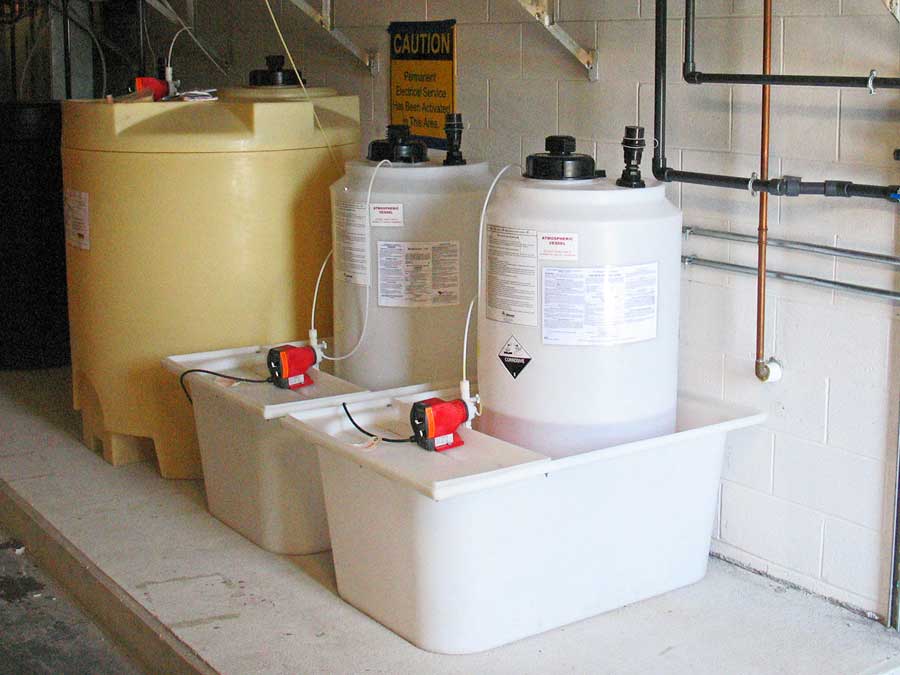 Containment tanks that house chemical products for a cooling water system