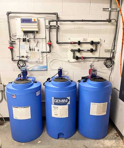 clarity water treatment setup with 3 chemical drums and controller