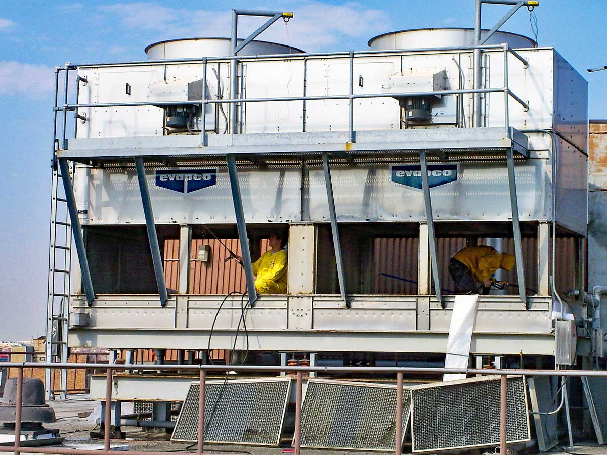 Two members of the clarity service team cleaning a cooling tower