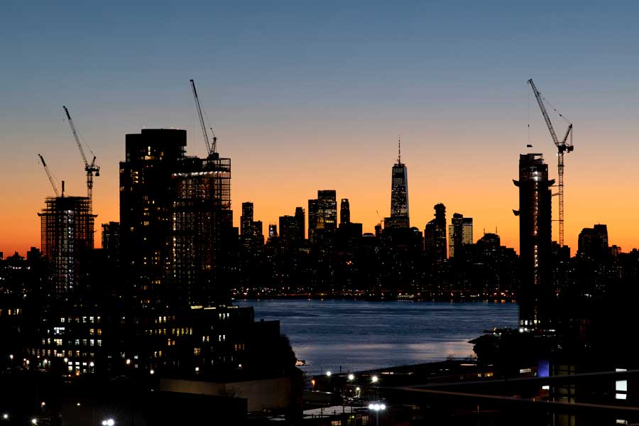 city skyline showing cranes and new construction